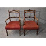 A pair of late Victorian carved walnut framed armchairs. H.76x50cm
