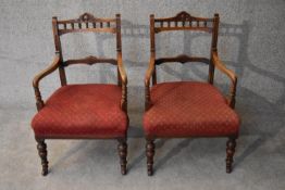 A pair of late Victorian carved walnut framed armchairs. H.76x50cm