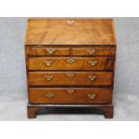 A Georgian mahogany bureau with fitted interior above two short over three long graduating drawers