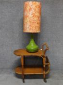 A 1970's vintage green glazed table lamp on vintage wicker drinks trolley H.70 W.73 D.46cm