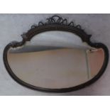 A shaped bevelled plate wall mirror with Regency style ribbon cresting. 87x113cm