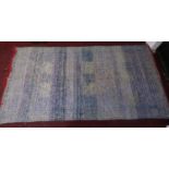 A double sided Kilim style rug with narrow geometric bands on blue field with red fringes 186x356cm