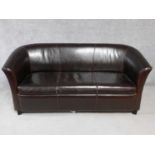 A tan leather two seater tub shaped sofa. H.78 W.173 D.83cm