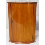 A small 19th century mahogany bow fronted corner cabinet. H.61 W.43 D.29cm