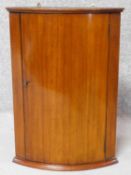 A small 19th century mahogany bow fronted corner cabinet. H.61 W.43 D.29cm