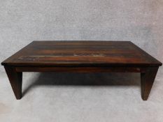 An Eastern teak coffee table on square tapering supports. H.45 L.140 W.70cm