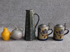 A collection of West German pottery. Including two salt glaze German steins with pewter lids and