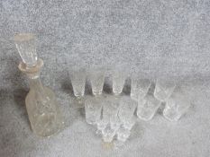 An antique cut crystal decanter with stopper and fifteen cut crystal glasses. Including a set of