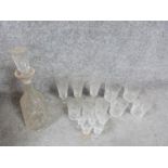 An antique cut crystal decanter with stopper and fifteen cut crystal glasses. Including a set of