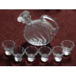 A set of six antique cut crystal shot glasses with faceted bases and a blown glass handled