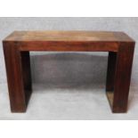 An Eastern hardwood console table with reeded block supports. H.77 W.120 D.45cm