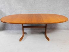 A mid 20th century G-Plan style teak extending dining table with leaf fitted to underside. H.72 W.