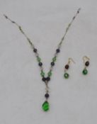 A vintage yellow metal wire Czech faceted glass green, purple and clear bead drop necklace with