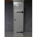 A 19th century painted hall cupboard with Gothic arched panel door on plinth base. H.200 W.55 D.45cm