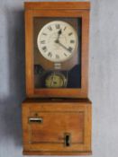 An antique oak wall hanging clocking-in clock by Gledhill-Brook-Time-Recorder Ltd. H.99 W.40 D.30cm