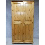 A contemporary pine wardrobe with mirror to interior of panel door. By English maker Victoria. H.183