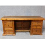 An Eastern teak pedestal desk with an arrangement of five drawers. H.78 W.179 D.59cm