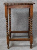 A mid 20th century oak lamp table on stretchered barley twist supports. H.73 L.46 W.47cm