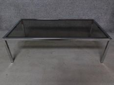 A chromium framed smoked glass plate top coffee table. H.35 W.114 D.59cm
