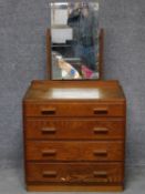 A vintage oak dressing chest of four drawers with swing mirror back, makers label to the back. H.141