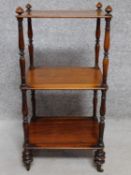 A mid 19th century rosewood whatnot with turned supports on brass cup casters. H.78 W.39 D.33cm