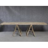 A vintage distressed painted pine trestle table on folding supports. H.270 L.76 W.59cm