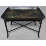 A black lacquered Chinoiserie decorated papier mache coffee table on bamboo stretchered supports.