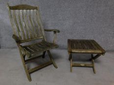 A weathered teak folding garden chair together with a matching folding table. H.103cm