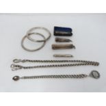 A collection of silver items. Including a pair of silver bangles, a silver fancy link watch chain