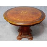 An Italian circular burr walnut dining table with floral inlaid top on carved pedestal base. H.75