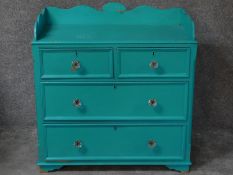 A 19th century painted pine chest of two short over two long drawers with shaped galleried back. H.