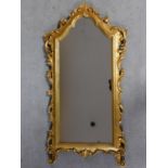 A carved giltwood framed wall mirror. H.103cm