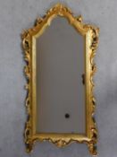 A carved giltwood framed wall mirror. H.103cm