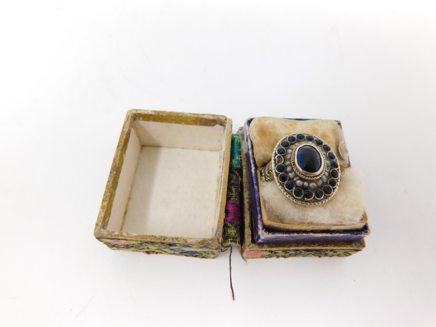 An antique Austrian silver, blue stone and seed pearl cluster ring. Set to centre with an oval - Image 2 of 15