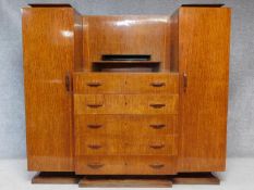 A vintage Continental Art Deco style rosewood teak and ebonised wardrobe with five central drawers