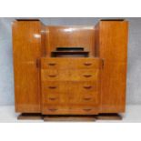 A vintage Continental Art Deco style rosewood teak and ebonised wardrobe with five central drawers