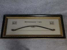A framed shadow box Asian/mayan replica of a bow and arrow. The bow features authentic styled