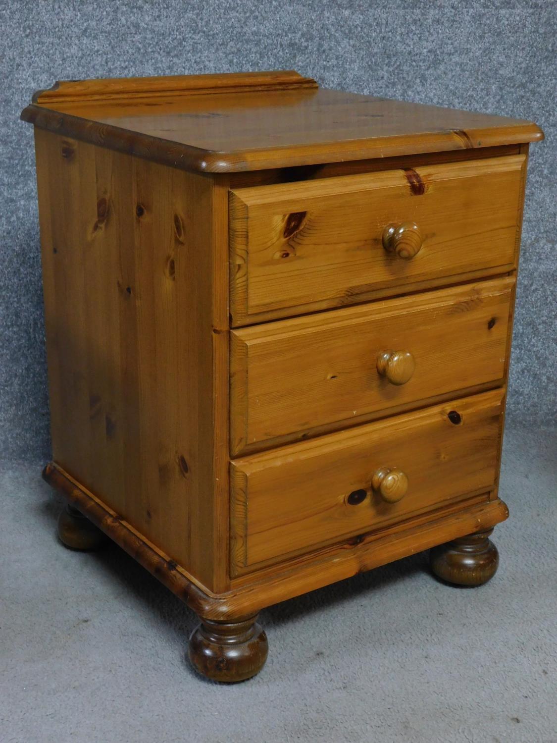 A pair of contemporary pine bedside chests with three drawers on casters, by English maker Victoria. - Image 3 of 5