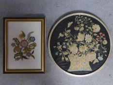 A framed and glazed antique hand embroidered picture of a vase of flowers along with a framed and