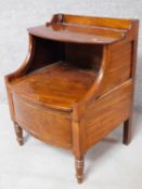 A Georgian mahogany night table with folding shelf and panel enclosing compartment on turned