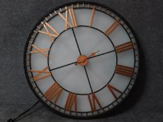 A large glass fronted shop display clock with gilded roman numerals, wired and internally lit.