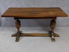 A Jacobean style oak refectory style dining table on carved stretchered baluster supports. H.77 W.