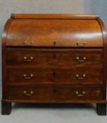 A 19th century continental mahogany cylinder top bureau with tooled leather lined slide out