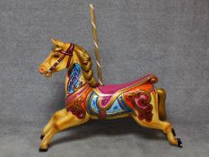 A fibreglass polychrome carousel horse and wooden supporting pole. H.128 W.134cm