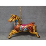 A fibreglass polychrome carousel horse and wooden supporting pole. H.128 W.134cm