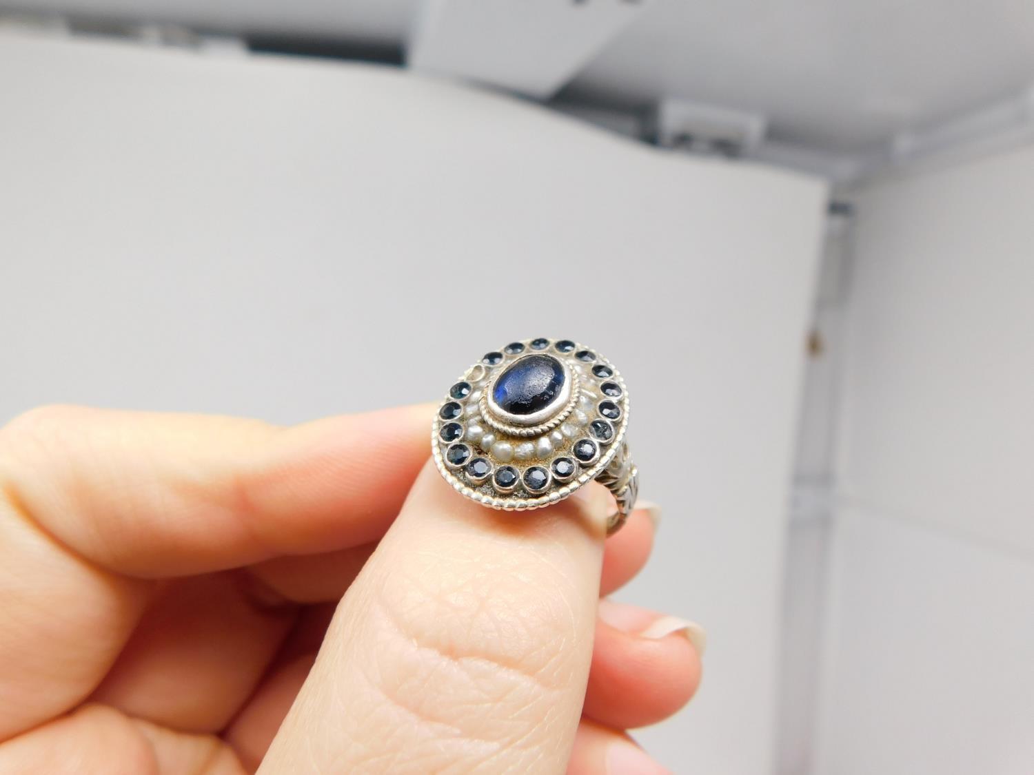 An antique Austrian silver, blue stone and seed pearl cluster ring. Set to centre with an oval - Image 13 of 15