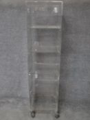 A set of perspex display shelves with four open sections on wheeled base. H.163 W.42 D.41cm