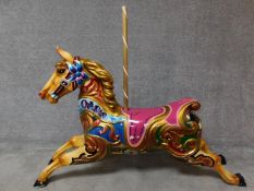 A fibreglass polychrome carousel horse and wooden supporting pole. H.128 W.160cm