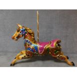 A fibreglass polychrome carousel horse and wooden supporting pole. H.128 W.160cm