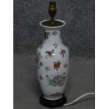 A vintage hand painted porcelain Chinese vase lamp base on carved hard wood stand. With floral and